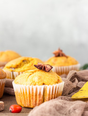 Sweet pumpkin or carrot muffins with fall spices. Autumn dessert. Healthy baking concept. Copy space.