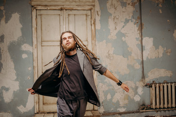 Emotion male portrait of man with dreadlocks in theater studio.
