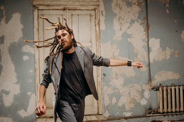 Emotion male portrait of man with dreadlocks in theater studio.
