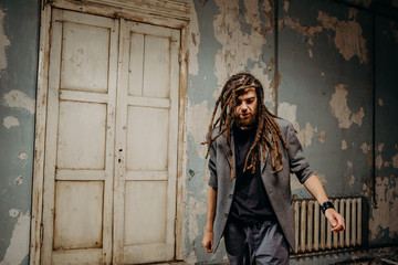 Emotion male portrait of man with dreadlocks in theater studio.