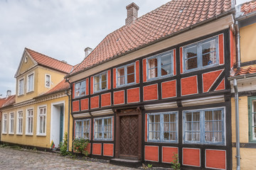 a romantic red half-timbered house on a cobblestone street in the weding-island of Aero, Denmark