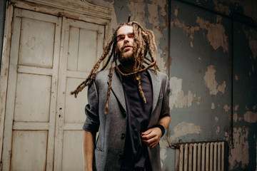 Emotion male portrait of man with dreadlocks in theater studio.