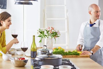 Smiling young couple cooking food in the kitchen
