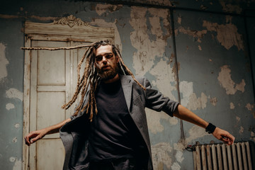 Emotion male portrait of man with dreadlocks in theater studio.