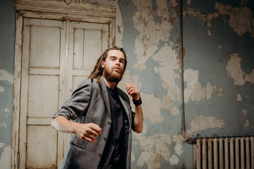 Emotion male portrait of man with dreadlocks in theater studio.