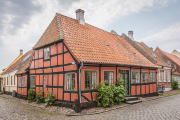An idyllic half-timbered house in the corner of two cobblestone-streets
