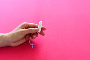 Hygienic tampon for women on pink background