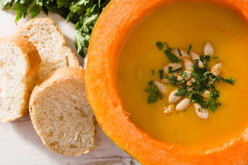 Pumpkin and carrot soup on white wooden table.Top view. Autumn food. 