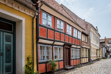 a romantic two-storey half-timbered house on an old cobblestone street