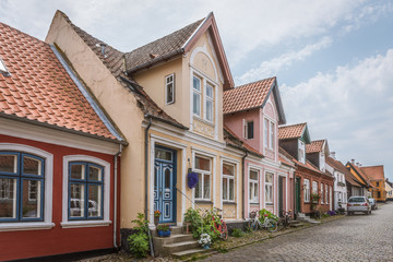 Fototapeta na wymiar Old romantic houses on a cobblestone street in Ærøskøbing
