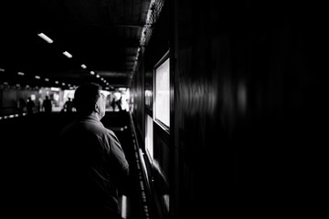old man looking out of a window