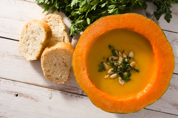 Pumpkin and carrot soup on white wooden table.Top view. Autumn food. 