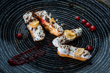 top view closeup four homemade eclairs with white topping