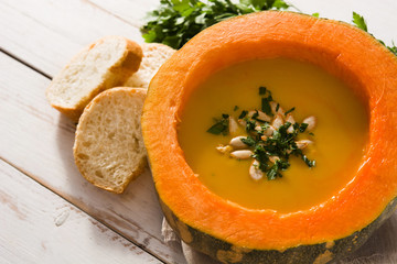 Pumpkin and carrot soup on white wooden table. Autumn food. 