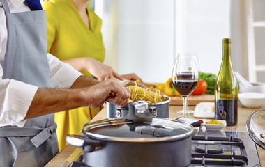 Smiling young couple cooking food in the kitchen