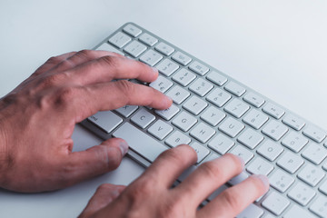 Hands writing on keyboard