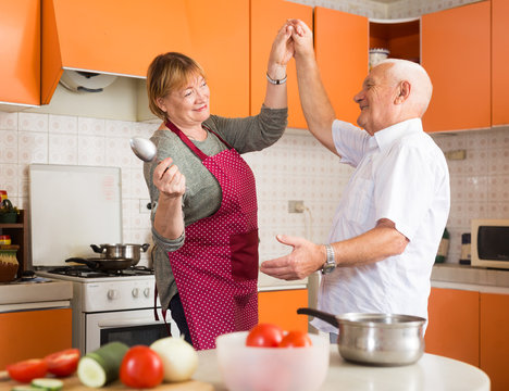 Senior Man And Woman Dancing In Kitchen