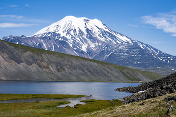 Naklejka na ściany i meble Picturesque summer volcanic landscape of Kamchatka Peninsula: view of active Volcano.