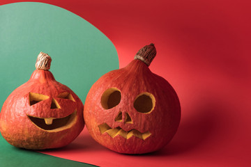 spooky Halloween pumpkins on red and green background