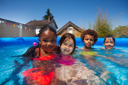 Group Small Kids Friends In Swimming Pool Together