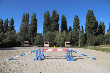 Obraz na płótnie Canvas Various colorful obstacles for equestrian training