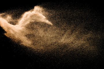 Dry river sand explosion isolated on black background. Abstract sand cloud.Brown colored sand...