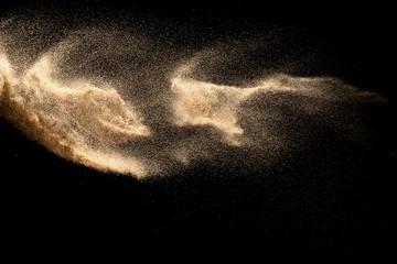 Dry river sand explosion isolated on black background. Abstract sand cloud.Brown colored sand...