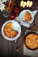 Homemade apple pie bathed with peach jam and honey. White flowers, jar of peach jam and honey. Fresh red apples and stevia leaves,