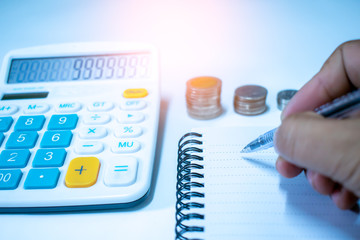 Business people are recording income and expenses With calculator to calculate numbers, financial...