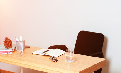 Workspace. Wooden table. Notebook on the table.