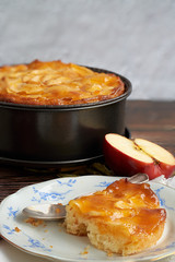 Homemade apple pie bathed with peach jam and honey. White flowers, jar of peach jam and honey....