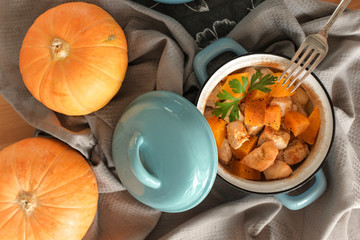 Pumpkin roast in a blue pan on a wooden table