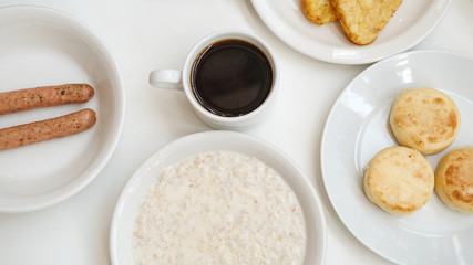 cheese pancakes, sausages, oatmeal, hash browns and coffee
