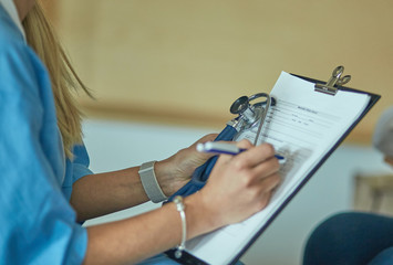 Friendly smiling doctor and patient sitting on the couch. Very