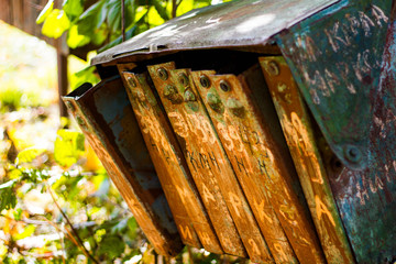 The rusty old mailboxes on the autumn nature. Abandoned iron mailboxes with house numbers.