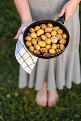 girl holding a pan with fried potatoes 