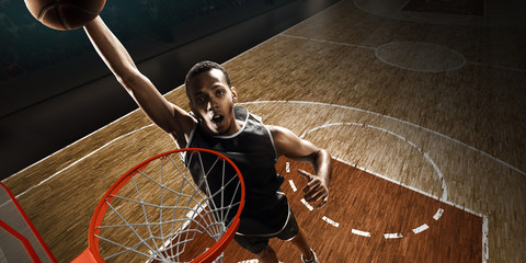African american basketball player near the hoop. High angle view. Slam Dunk