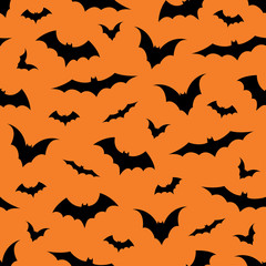 Seamless pattern with bats on orange background, vector illustration