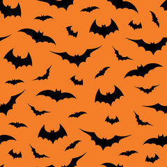 Seamless pattern with bats on orange background, vector illustration