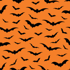 Seamless pattern with bats on orange background, vector illustration
