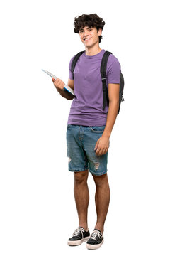 A full-length shot of a Young student man with arms crossed and looking forward over isolated white background