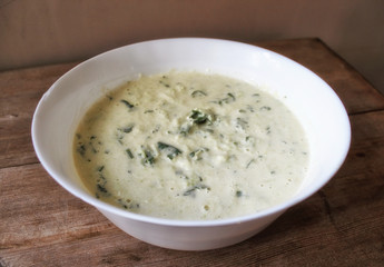 Dough for vegetable Zucchini pancakes with herbs in white bowl. Vegetable harvesting cooking concept