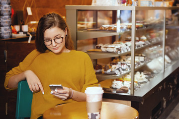 Portrait of beautiful young woman using her digital tablet in cafe.