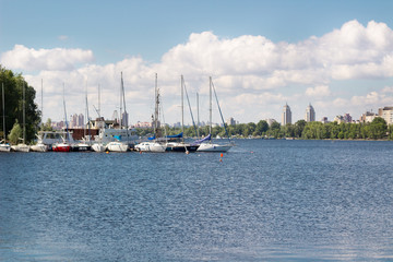 Fototapeta na wymiar Small city marina on a river with sailing yachts and boats