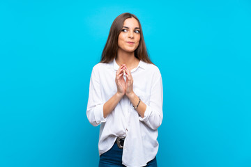 Young woman over isolated blue background scheming something
