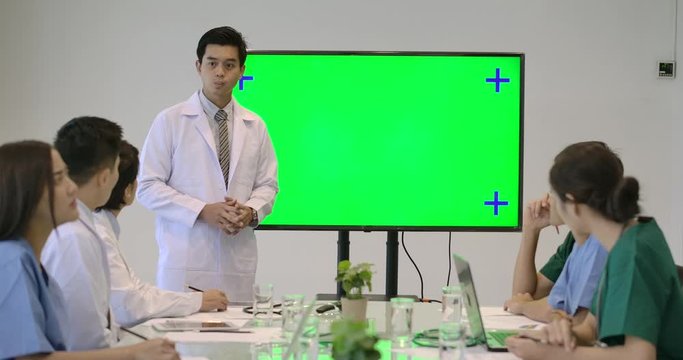 4K Medical research team in a meeting, Doctors making presentation with green screen monitor in video conference meeting at hospital.