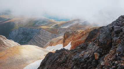 Route through mountain peaks and hills through majestic landscapes. Active tourists, hiking