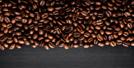 Coffee beans on wooden background.