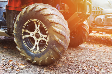 ATV in the forest, in the mud. Wheels and ATV elements close-up in the mud. Active leisure, sports...