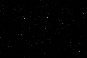 Chaotic white bokeh on a black background, light spots texture, abstraction, falling snow, starry sky, bright glare of light texture